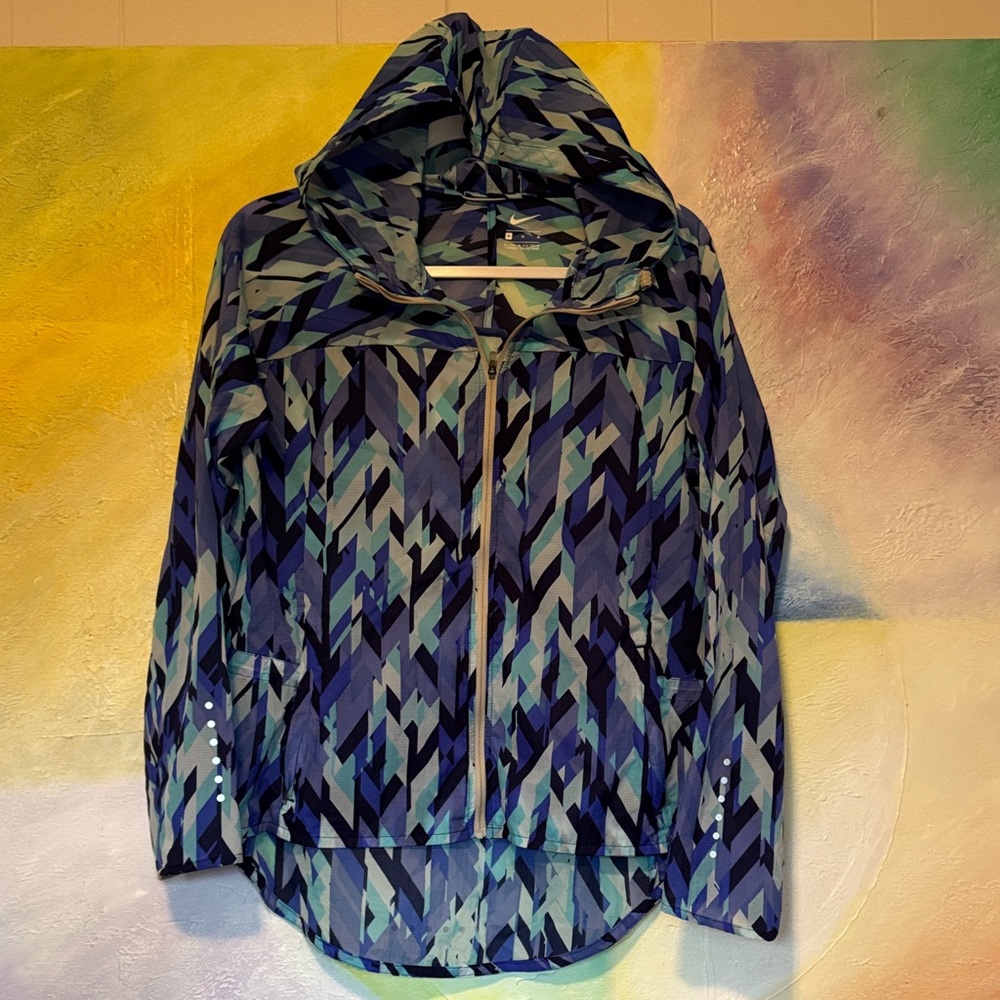 Nike “Impossibly Light” Running Jacket women blue and teal geometric pattern.